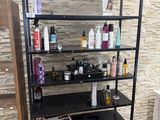 a black shelf with a lot of beauty products on it