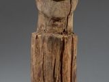 wooden sculpture of a man ' s face on a wooden base