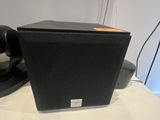 an image of a black speaker sitting on top of a white table