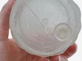 a person holding a plastic object in their hand