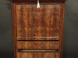 an antique wooden cabinet with marble top and drawers