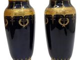 pair of black and gold vases on a white background