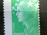 the stamp is green and white with a woman ' s face on it