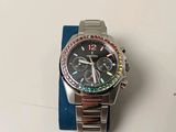 a watch that is sitting on top of a blue cloth