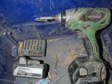 a drillet and other tools in a blue bin