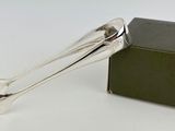 a silver spoon sitting next to a box on a table