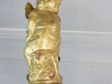a gold statue hanging from the ceiling of a room