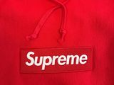 a red supreme hoodie with the supreme logo on it
