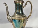 silver plated teapot with a blue and green glaze on it