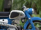 a blue motorcycle parked in front of a building