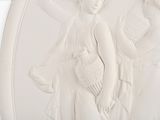 a white relief of a woman holding a bird