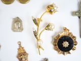 a lot of gold and silver jewelry on a white surface