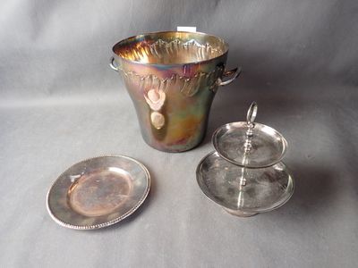 a silver cup and saucer sitting next to a silver plate