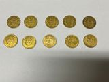 a close up of a bunch of gold coins sitting on top of a table