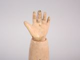 an image of a clay hand holding something up in the air