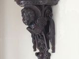 carvings on the wall of a home in a white walled room