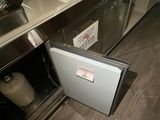 a small refrigerator with a door open in a kitchen