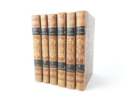three books are stacked on top of each other on a white surface