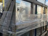 a truck that is parked next to a building that has been wrapped in plastic