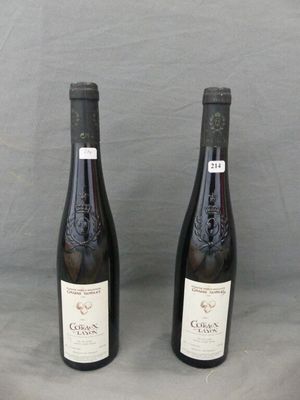 two bottles of wine sitting next to each other on a table