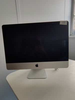a computer monitor sitting on top of a white desk