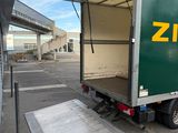 a truck that is parked in a parking lot with its door open