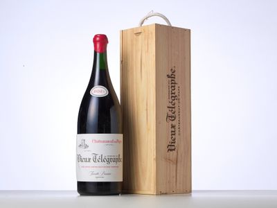 a bottle of wine sitting next to a wooden box