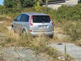 a silver car that is parked in the grass