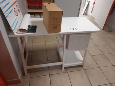 a white table with a box on it and a phone on it