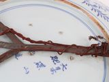 a pair of rusty scissors on a plate with writing on it