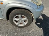 a car that has a flat tire on the side of the road