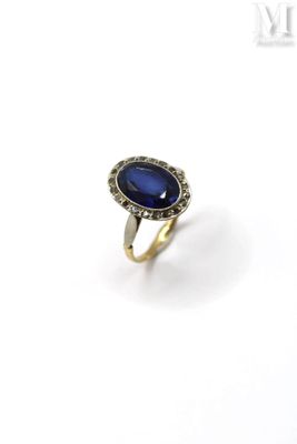 a close up of a ring with a blue stone on it