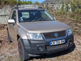 a car that is parked in the dirt near a fence