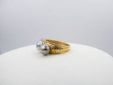 an image of a close up of a ring with a pearl on it