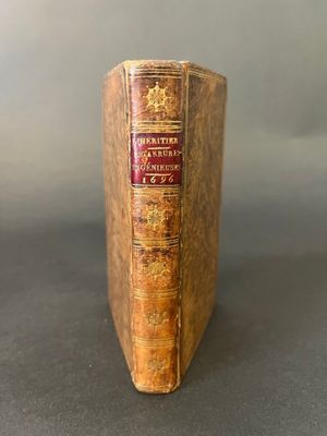 an old book sitting on top of a table next to a black table