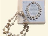a pearl necklace and a book with a picture on it