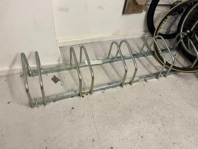 a bike that is parked next to a bike rack