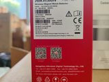 the back of a red box with a sticker on it sitting on top of a table