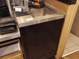 a small kitchen with a stove, sink, microwave, and dishwasher