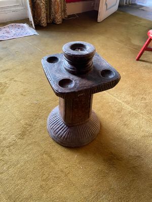 a small table with a bowl on it in the middle of a living room