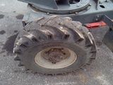 a tractor that is sitting on the ground next to a truck