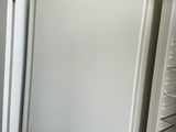 two white refrigerators in a kitchen next to each other