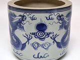 a blue and white vase with a dragon design on it