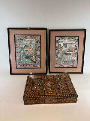two framed pictures of a couple of wooden boxes sitting on a table