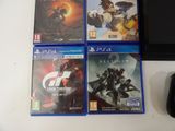 three ps4 games are sitting on a table next to a mouse