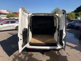the back of a white van with its doors open in a parking lot
