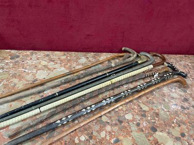 a lot of different types of walking sticks on a table