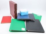 a lot of different colored binders on a white surface