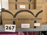 boxes of wine and wine glasses on a shelf in a store
