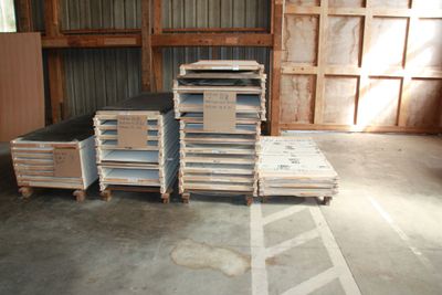 several stacks of pallets are stacked up in a warehouse